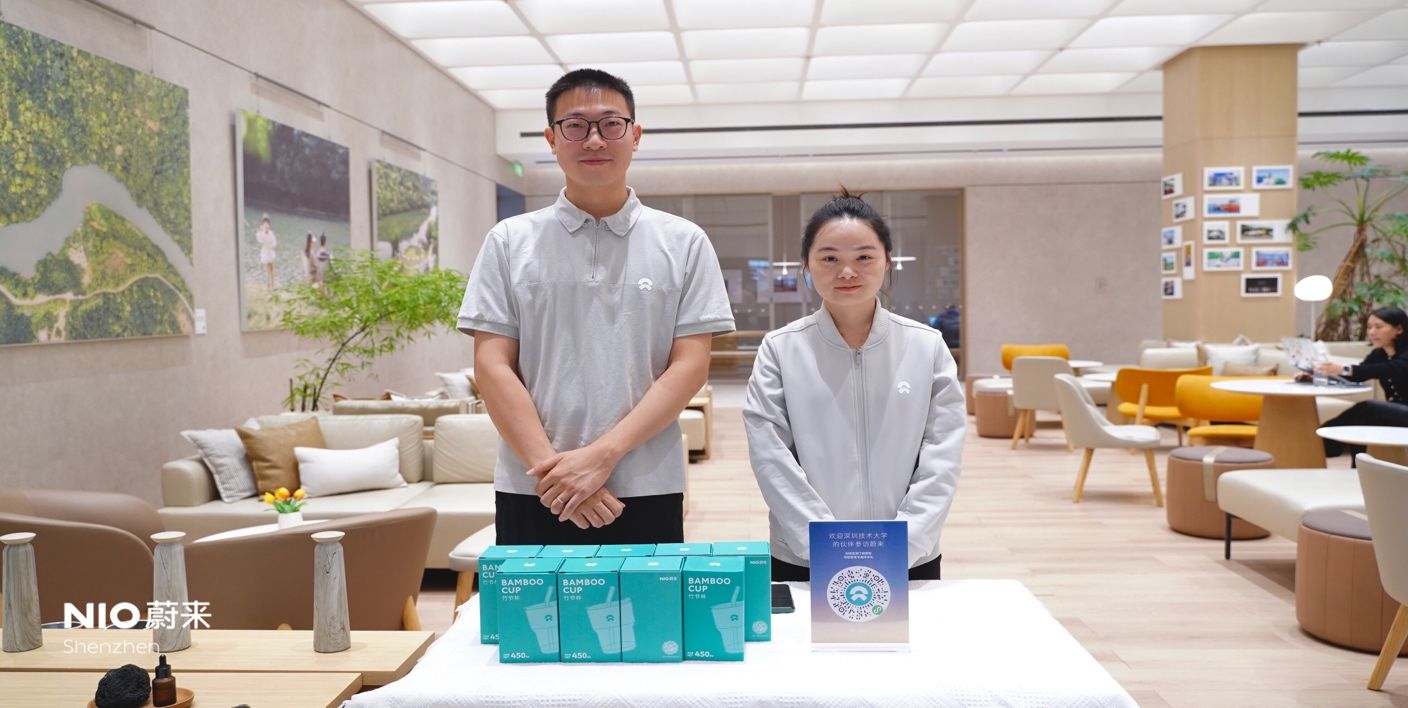 A person and person standing next to a table with boxesAI-generated content may be incorrect.