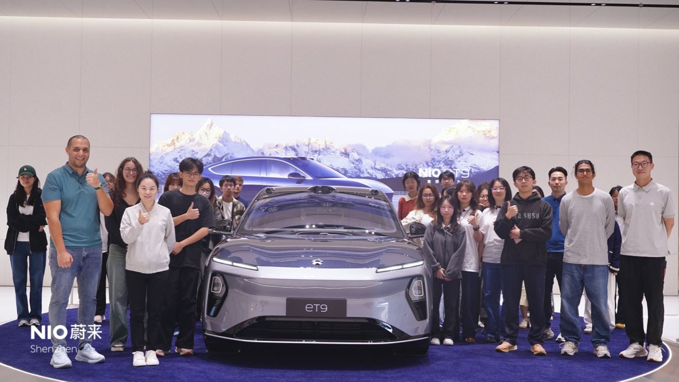 A group of people standing in front of a carAI-generated content may be incorrect.