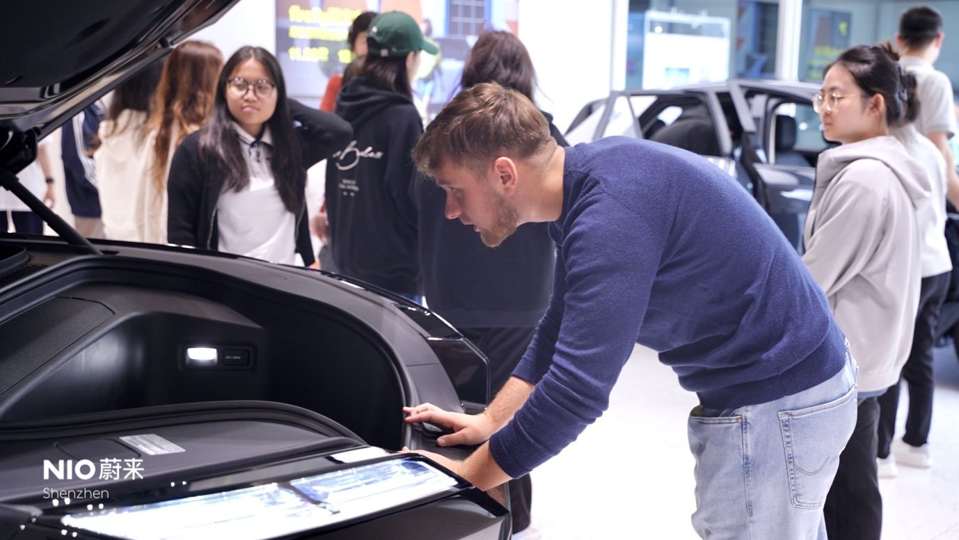 A person looking at the trunk of a carAI-generated content may be incorrect.